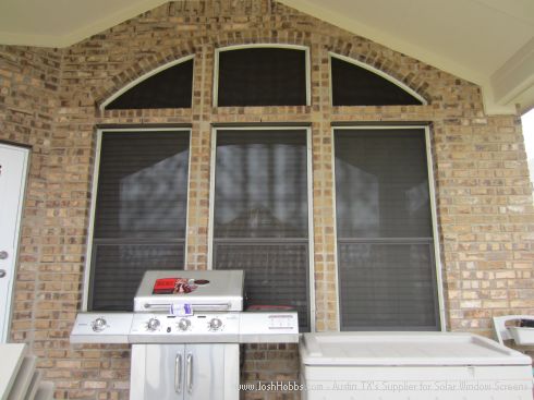 Displaying three arched solar window screens.